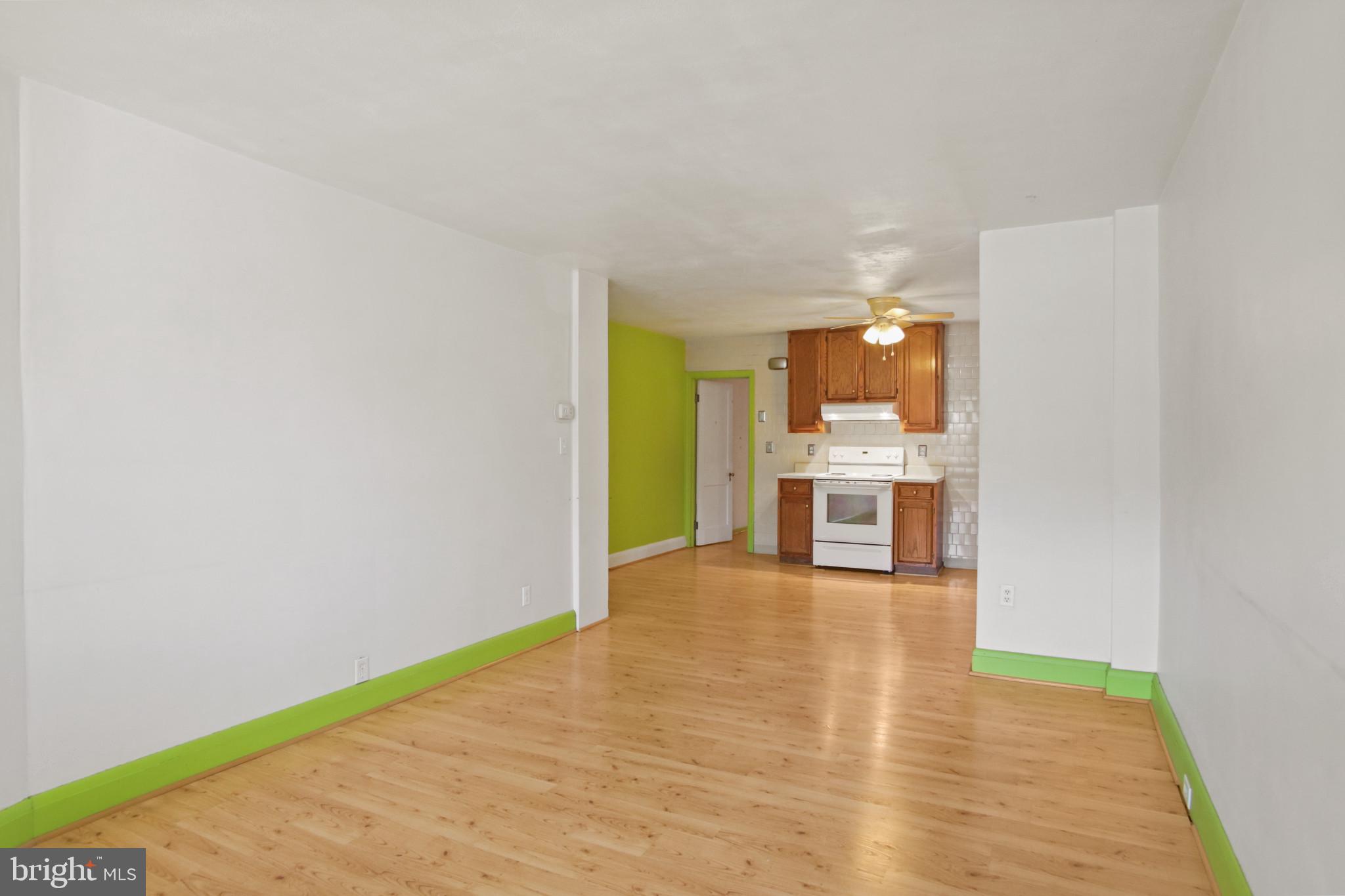 102 Willow Spring Road Baltimore, MD 21222 - Photo 5 of 28 a view of a kitchen with furniture and wooden floor