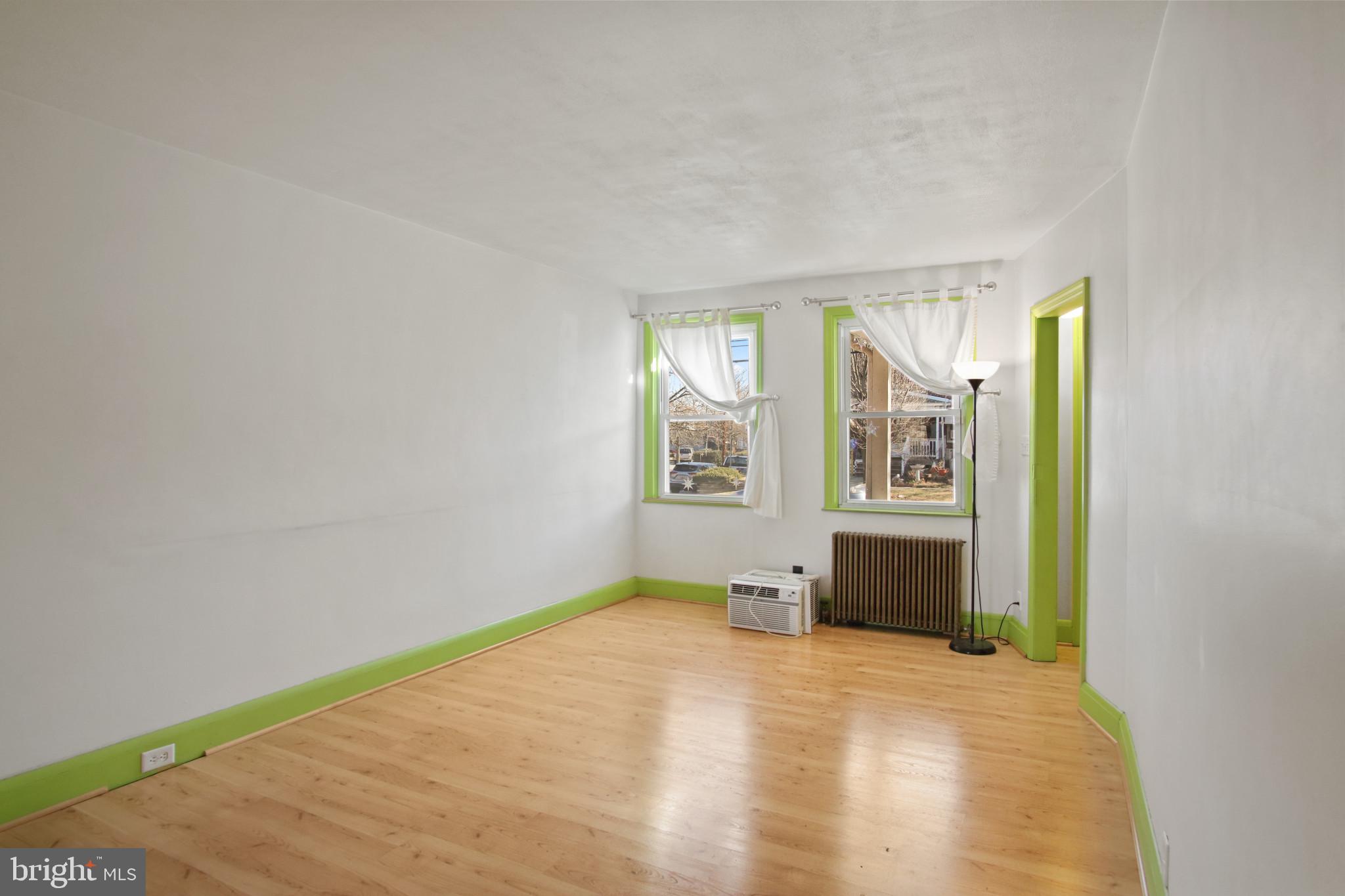 102 Willow Spring Road Baltimore, MD 21222 - Photo 6 of 28 wooden floor in an empty room and a window