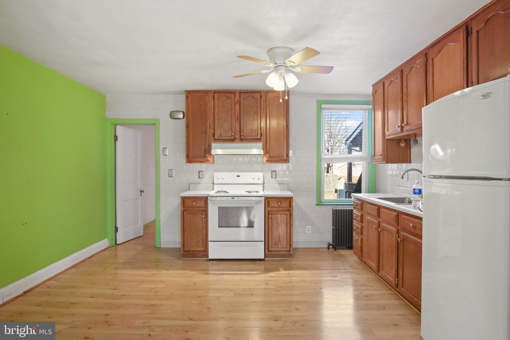 102 Willow Spring Road Baltimore, MD 21222 - Photo 8 of 28 a kitchen with a stove a sink and a refrigerator
