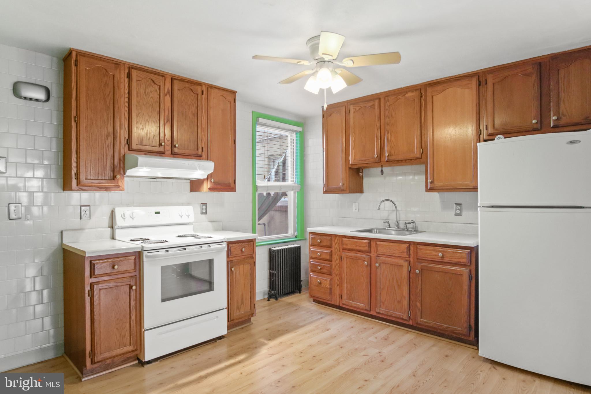 102 Willow Spring Road Baltimore, MD 21222 - Photo 9 of 28 a kitchen with a stove sink and cabinets