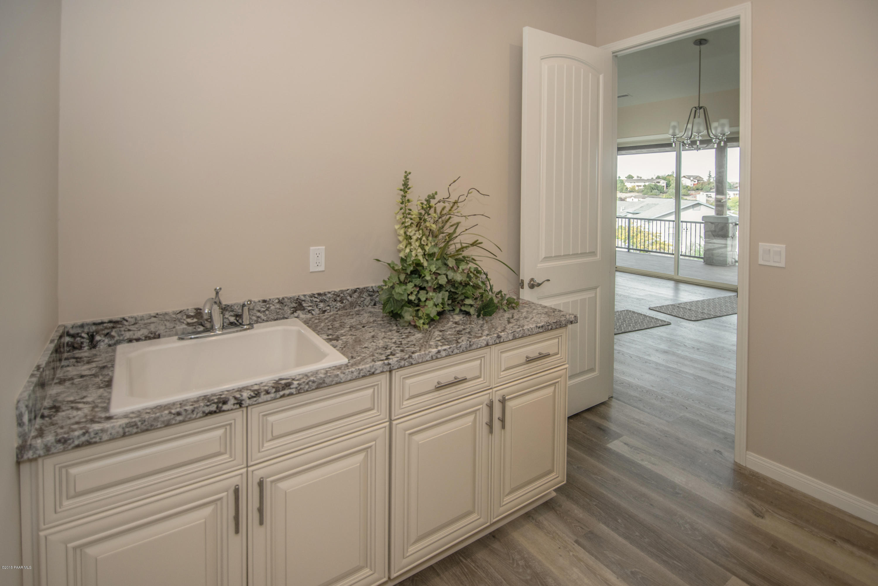 531 Miracle Rider Road Prescott, AZ 86301 - Photo 15 of 31 a sink with white cabinets and wooden floor