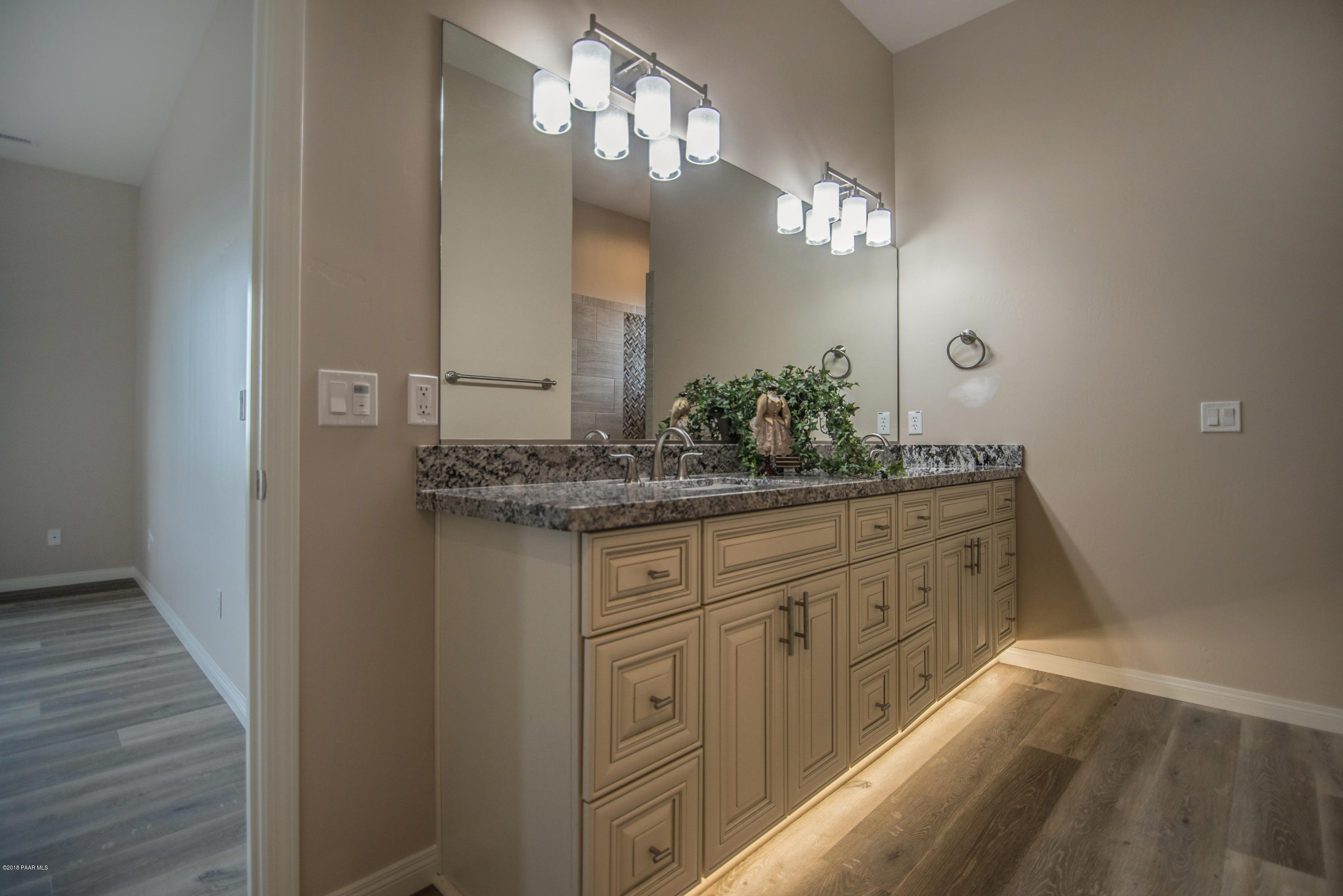 531 Miracle Rider Road Prescott, AZ 86301 - Photo 20 of 31 a bathroom with a granite countertop sink and a mirror
