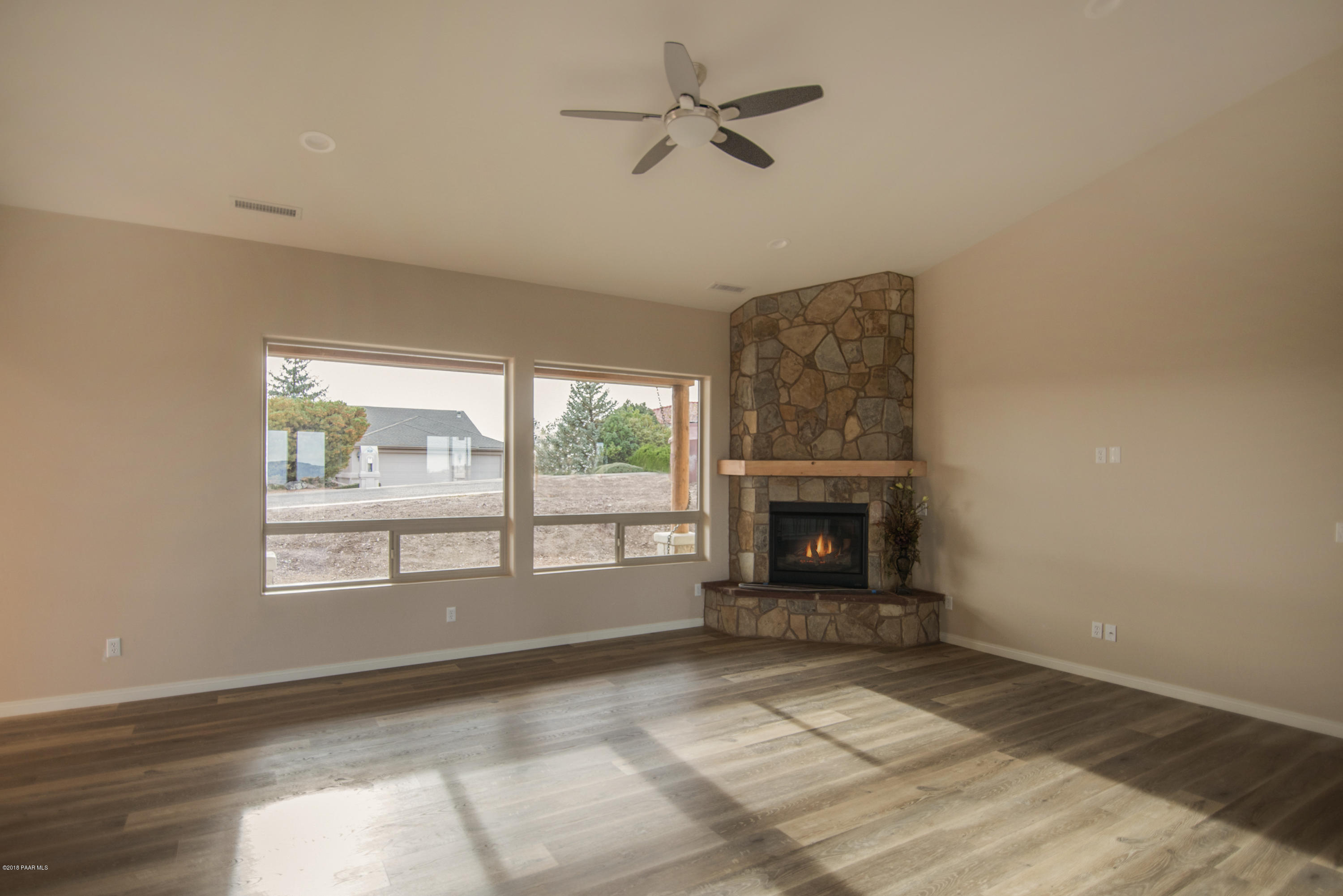 531 Miracle Rider Road Prescott, AZ 86301 - Photo 24 of 31 a view of an empty room with a fireplace and a window