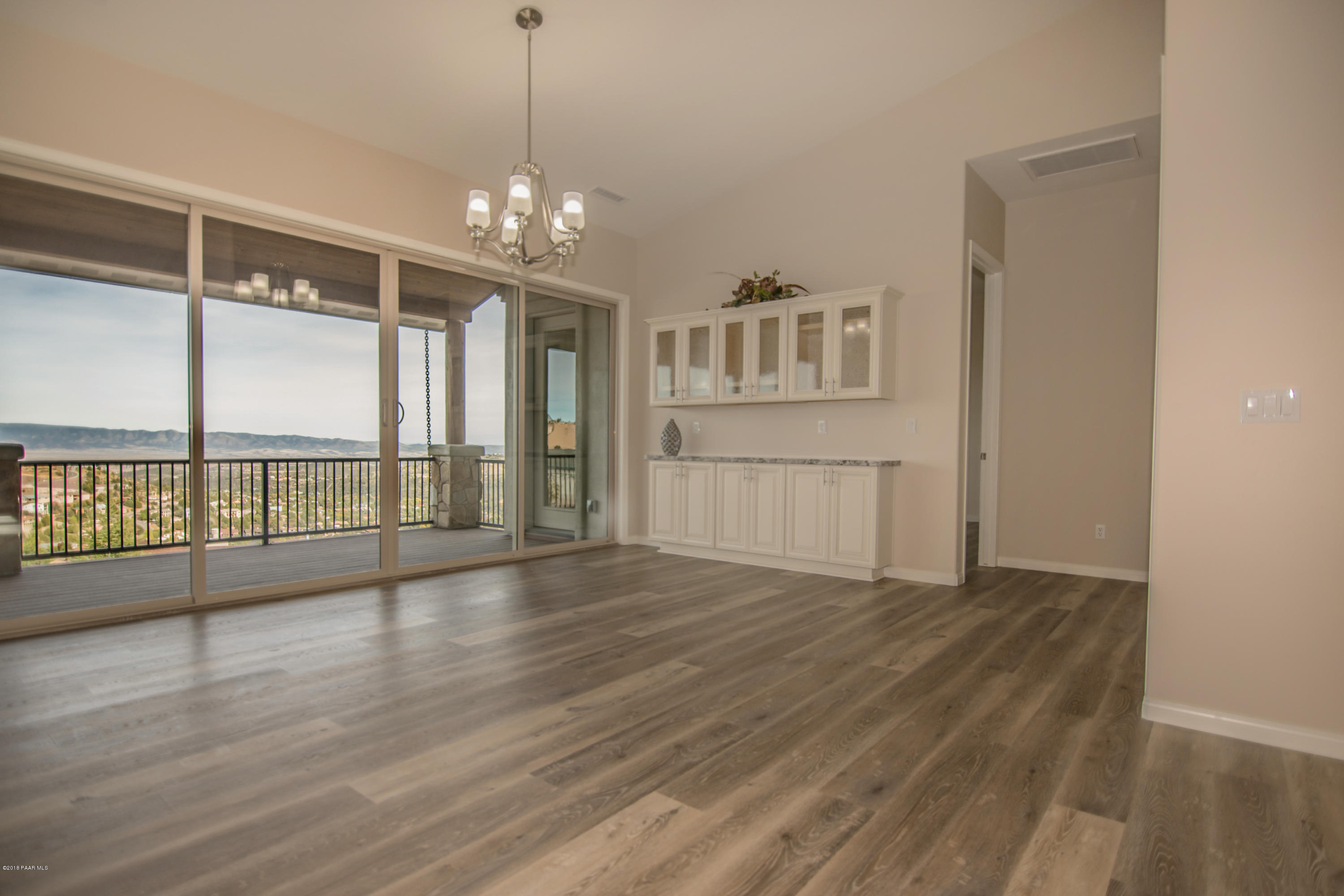 531 Miracle Rider Road Prescott, AZ 86301 - Photo 3 of 31 a view of an empty room with wooden floor and a window