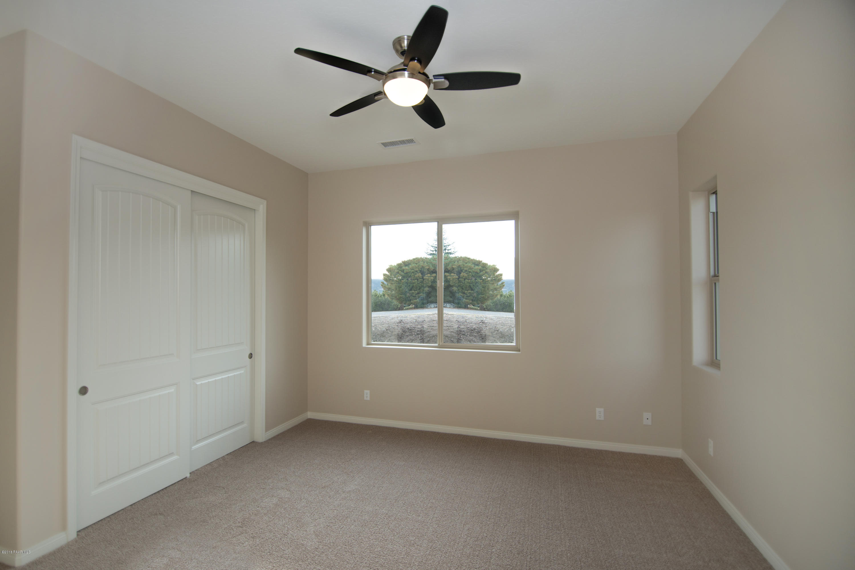 531 Miracle Rider Road Prescott, AZ 86301 - Photo 9 of 31 an empty room with a window and a fan