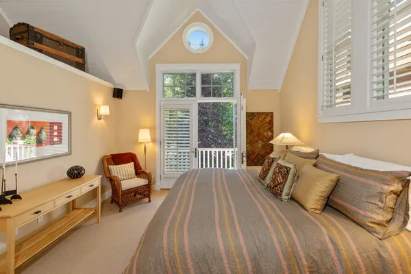 a living room with furniture and large windows