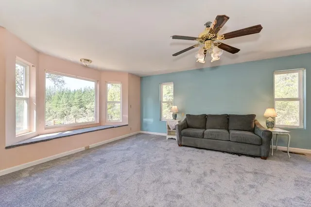 a living room with furniture and windows