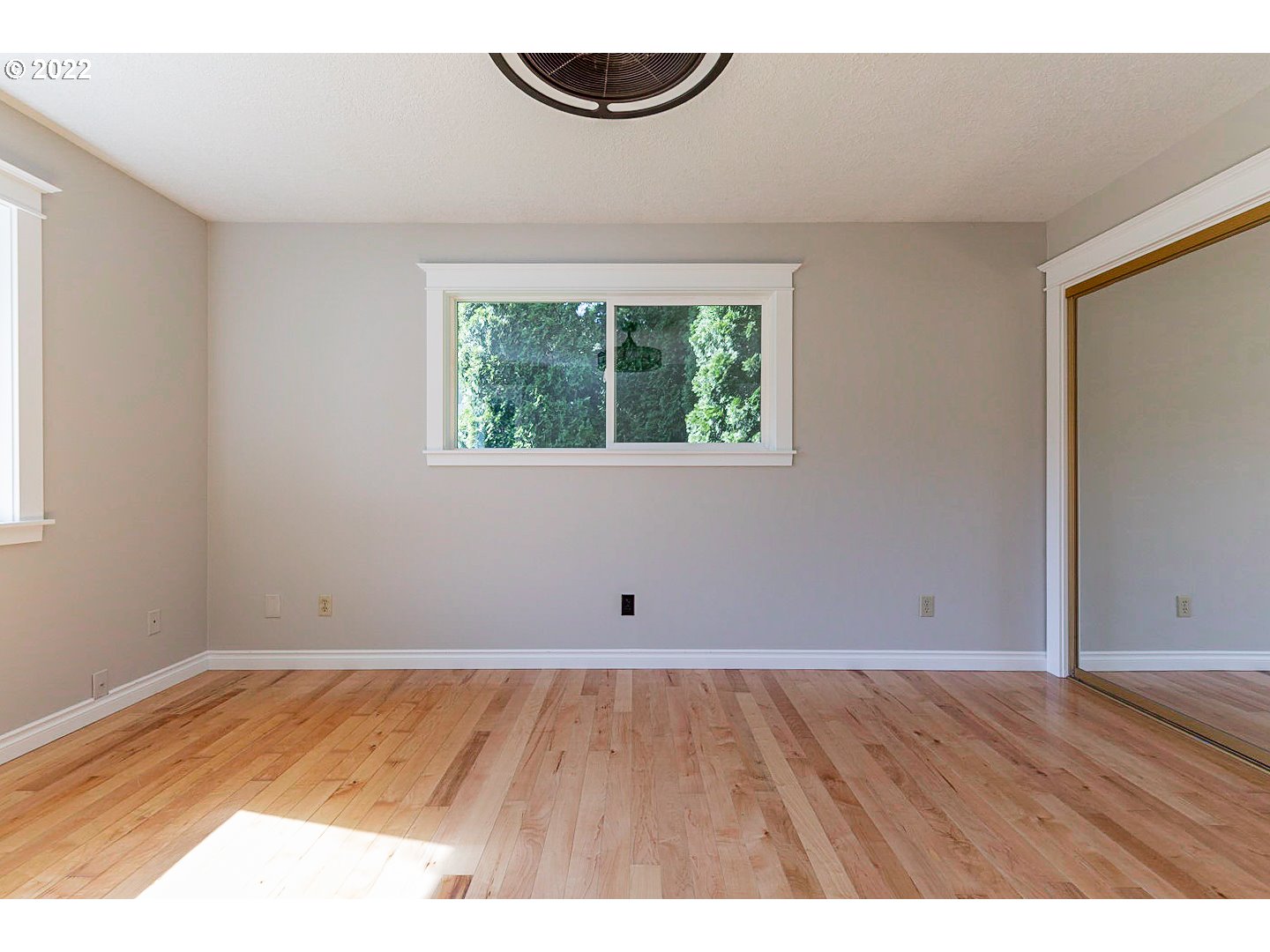1302 Southwest 19th Drive Gresham, OR 97080 - Photo 20 of 32 an empty room with wooden floor and windows