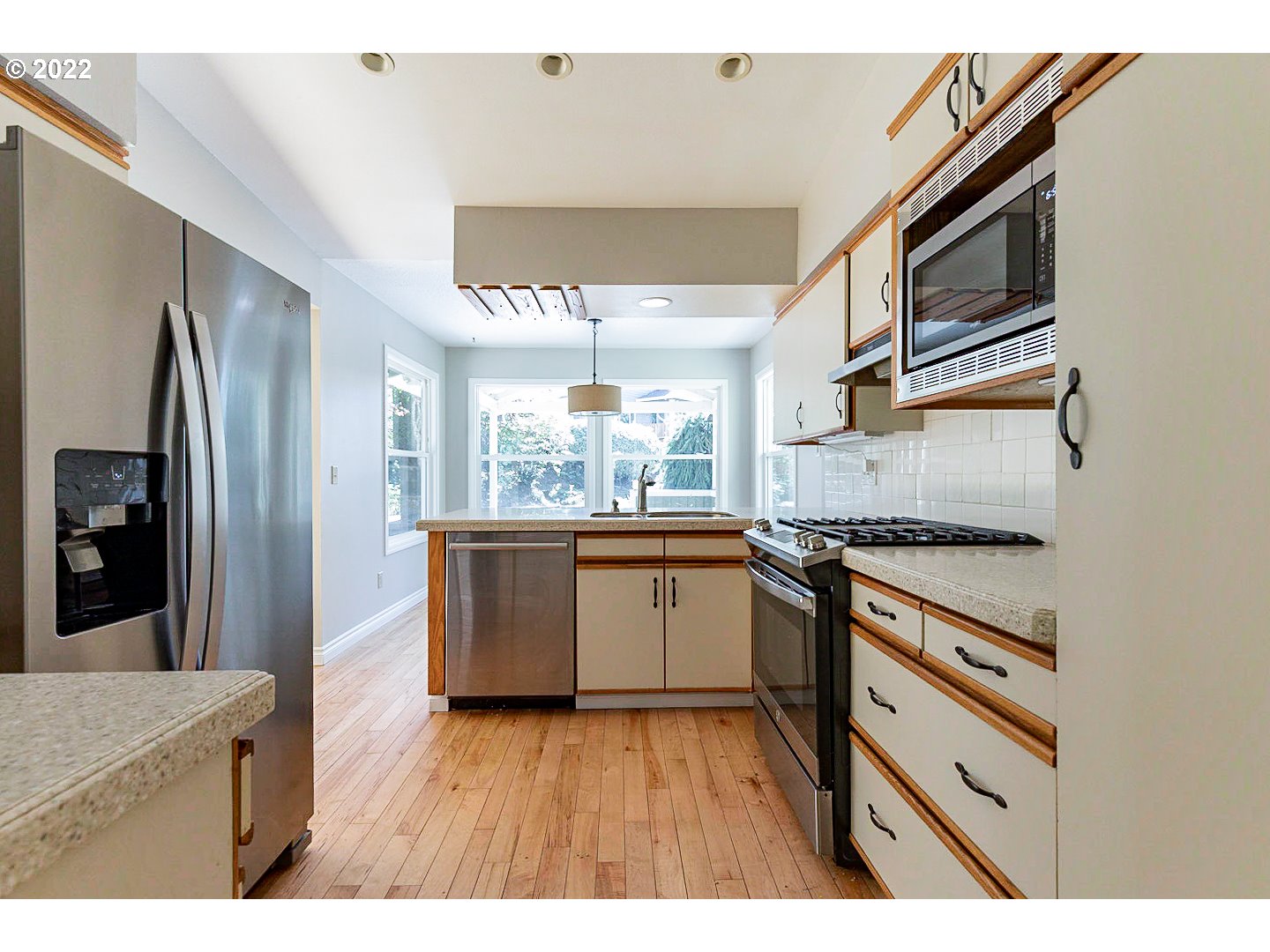 1302 Southwest 19th Drive Gresham, OR 97080 - Photo 2 of 32 a kitchen with stainless steel appliances granite countertop a stove a sink and a refrigerator