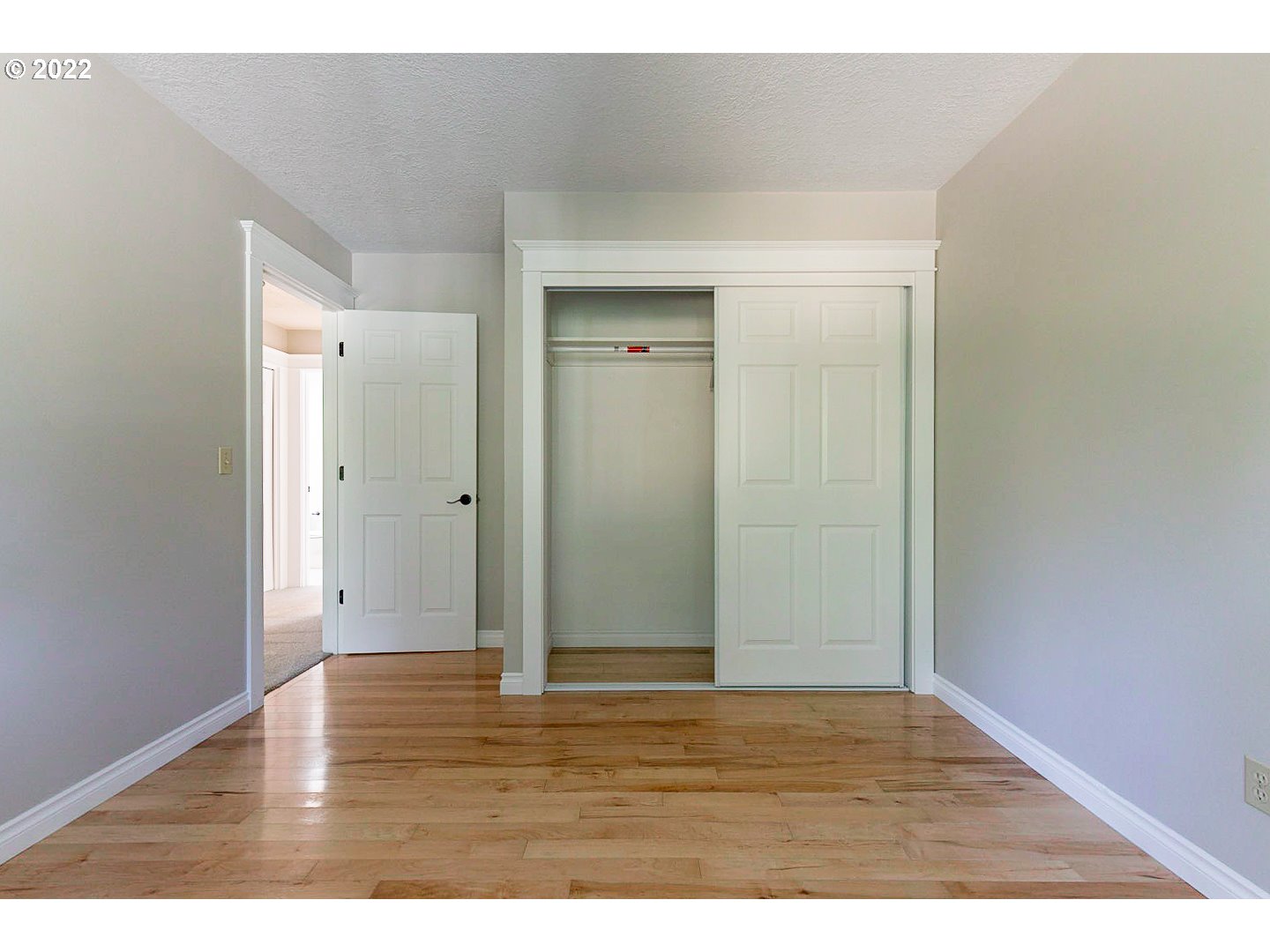 1302 Southwest 19th Drive Gresham, OR 97080 - Photo 23 of 32 a view of an empty room with wooden floor