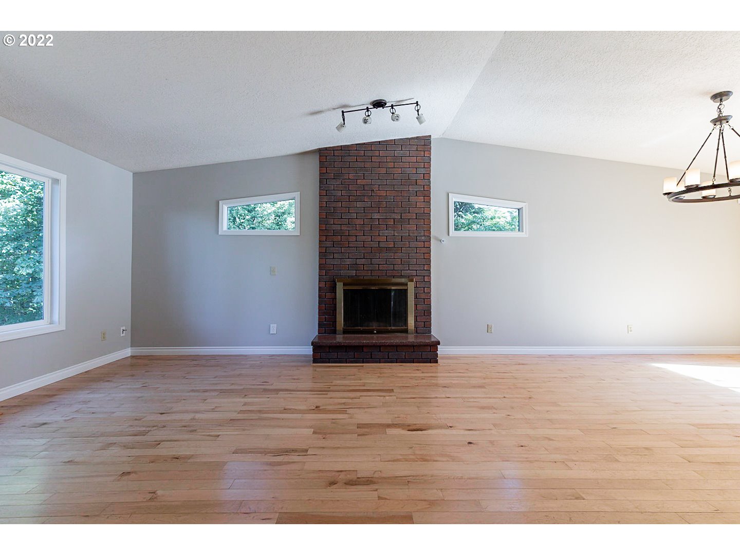 1302 Southwest 19th Drive Gresham, OR 97080 - Photo 3 of 32 a view of an empty room with window and fireplace