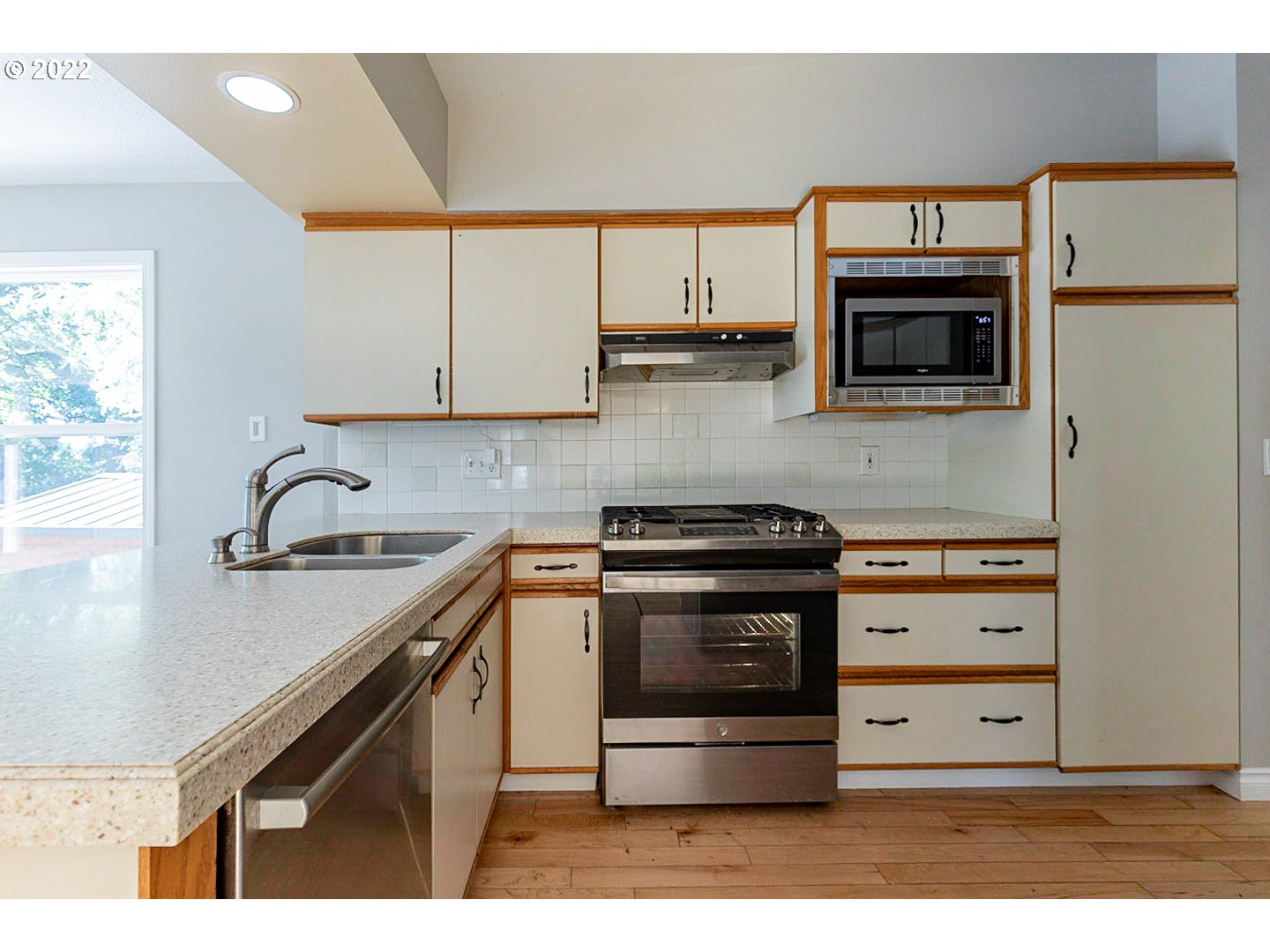 1302 Southwest 19th Drive Gresham, OR 97080 - Photo 6 of 32 a kitchen with stainless steel appliances granite countertop a stove and a microwave
