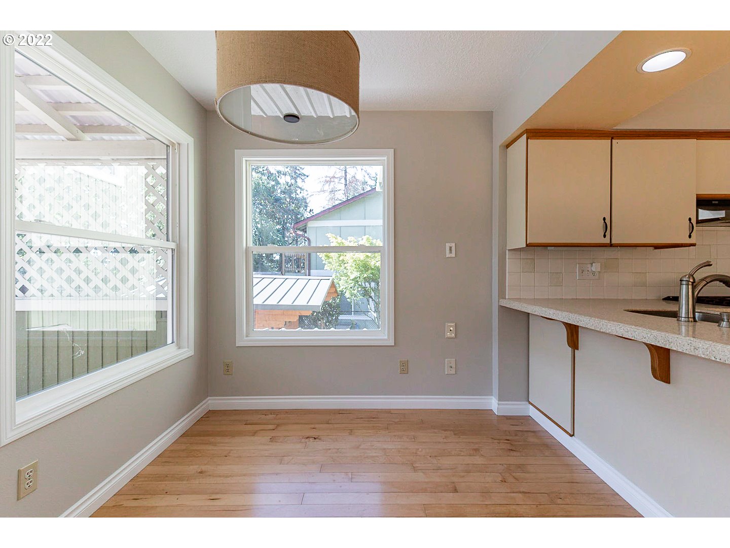 1302 Southwest 19th Drive Gresham, OR 97080 - Photo 9 of 32 a view of an empty room with a window and wooden floor