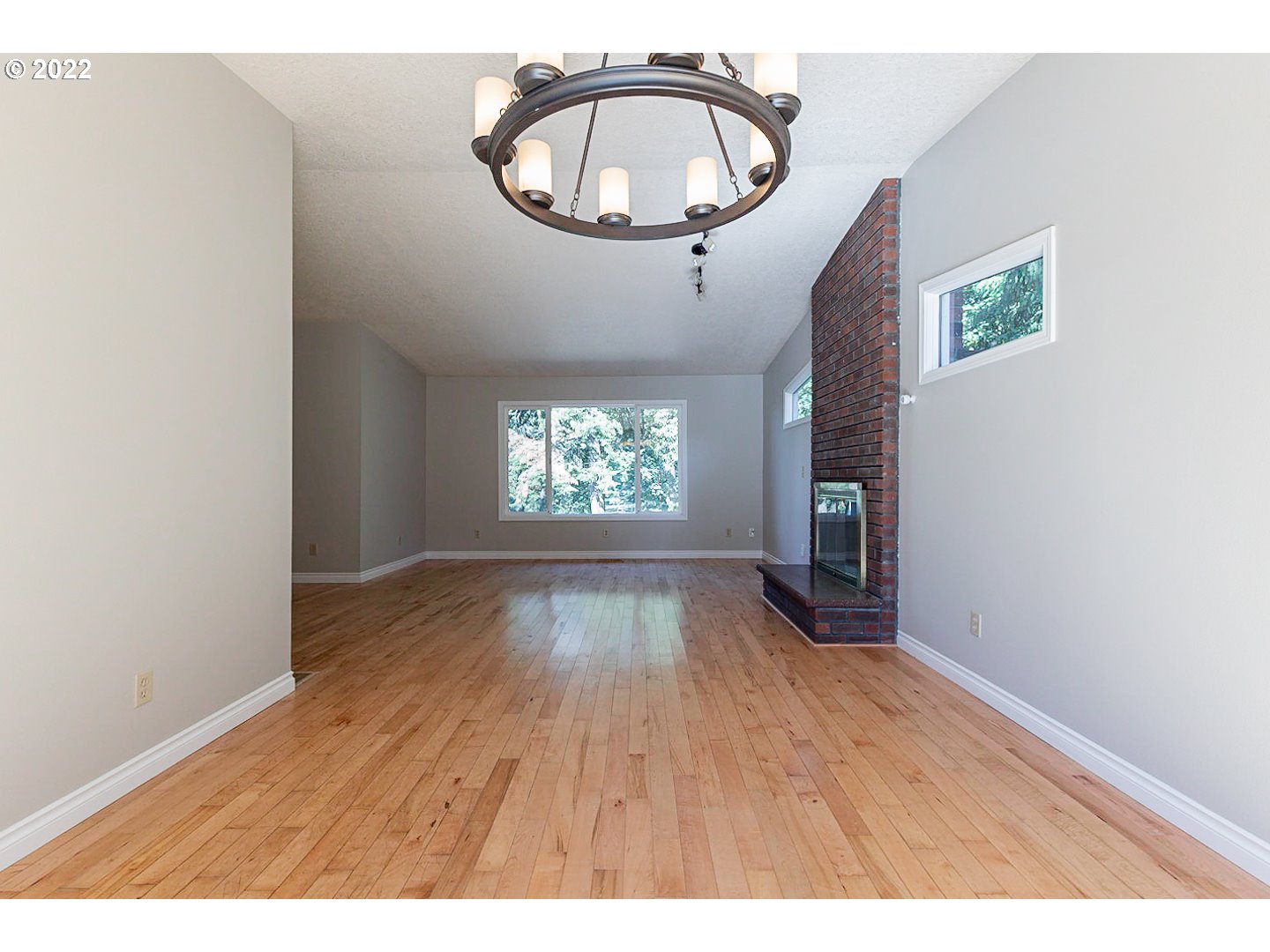 1302 Southwest 19th Drive Gresham, OR 97080 - Photo 10 of 32 an empty room with wooden floor and windows