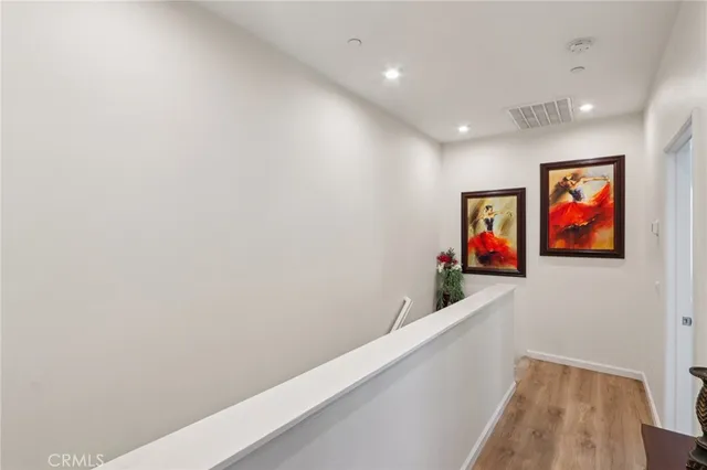 a bed sitting in a spacious bedroom next to a window