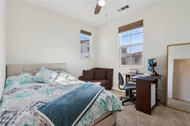 a white house with a yard and plant in front of it