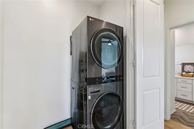 a view of a white house with a small yard and plants