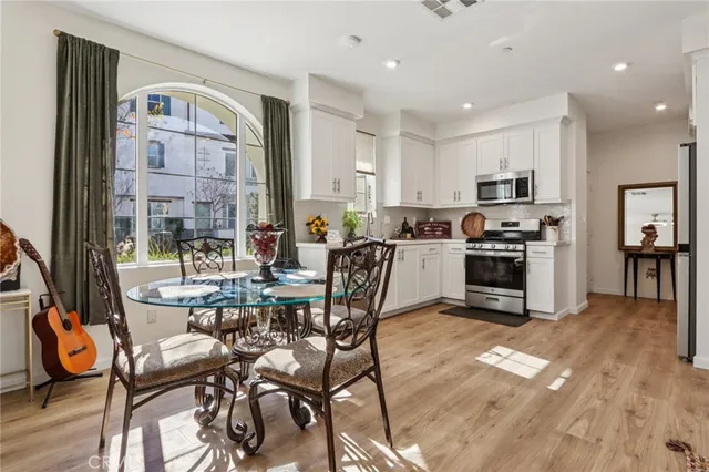 a kitchen with a refrigerator stove and wooden cabinets