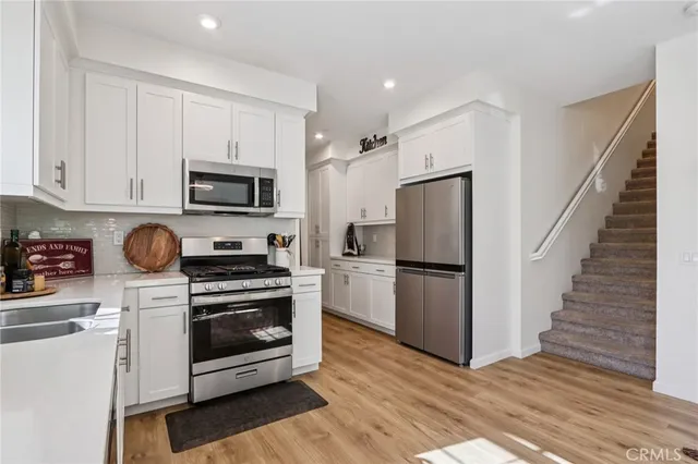 a kitchen with a refrigerator stove and sink