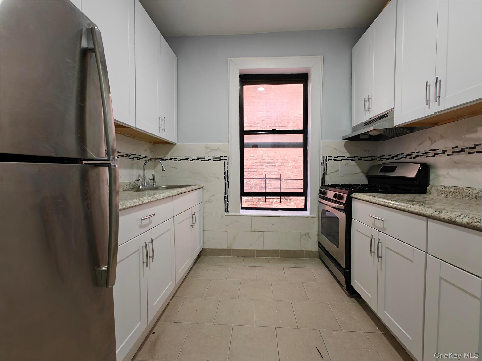 30 Macombs Place, Unit 44 Manhattan, NY 10039 - Photo 6 of 13 a kitchen with a refrigerator sink and cabinets
