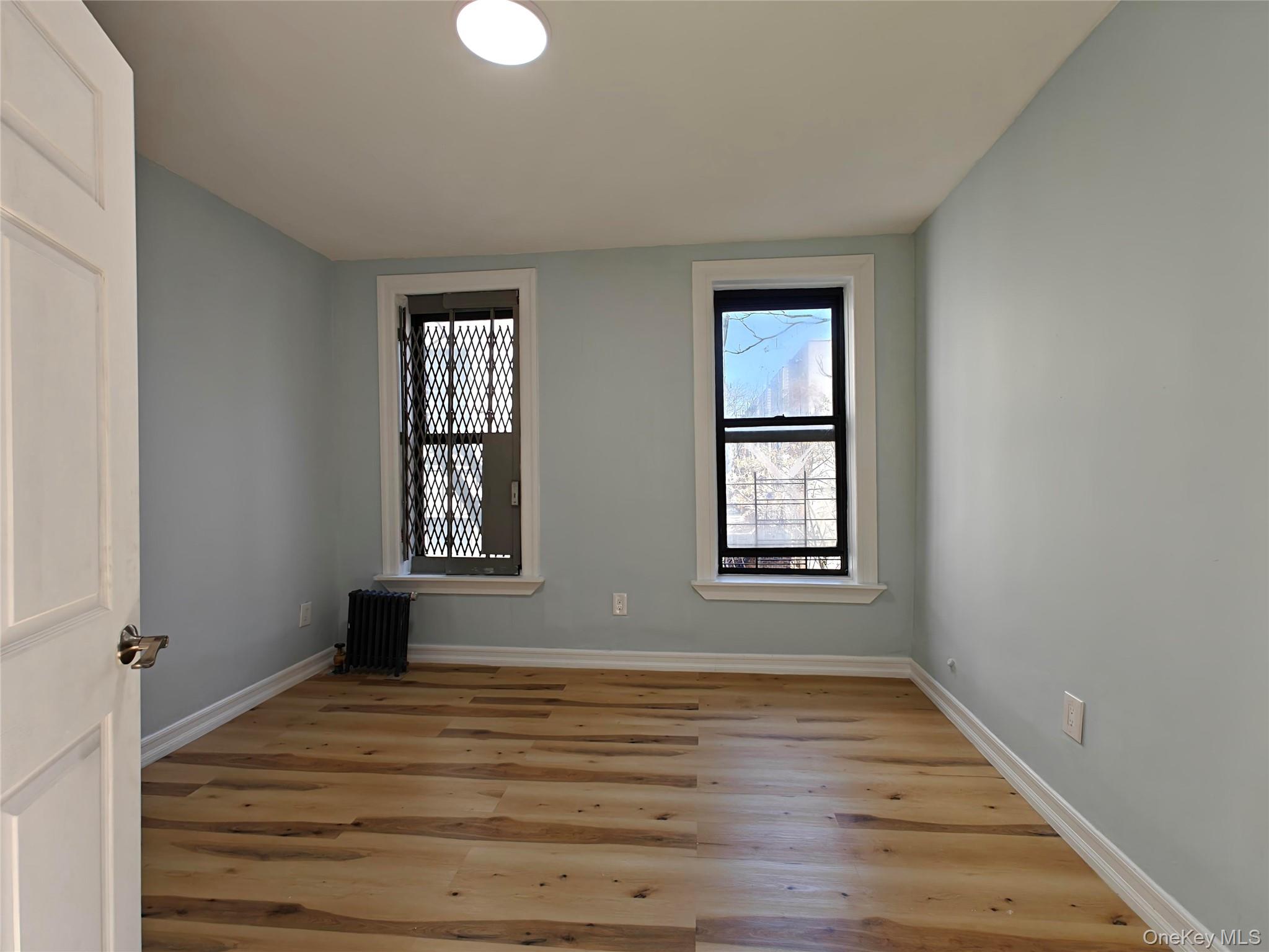 30 Macombs Place, Unit 44 Manhattan, NY 10039 - Photo 10 of 13 a view of an empty room with wooden floor and a window