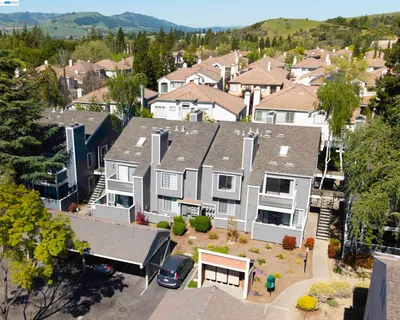 an aerial view of residential houses and outdoor space
