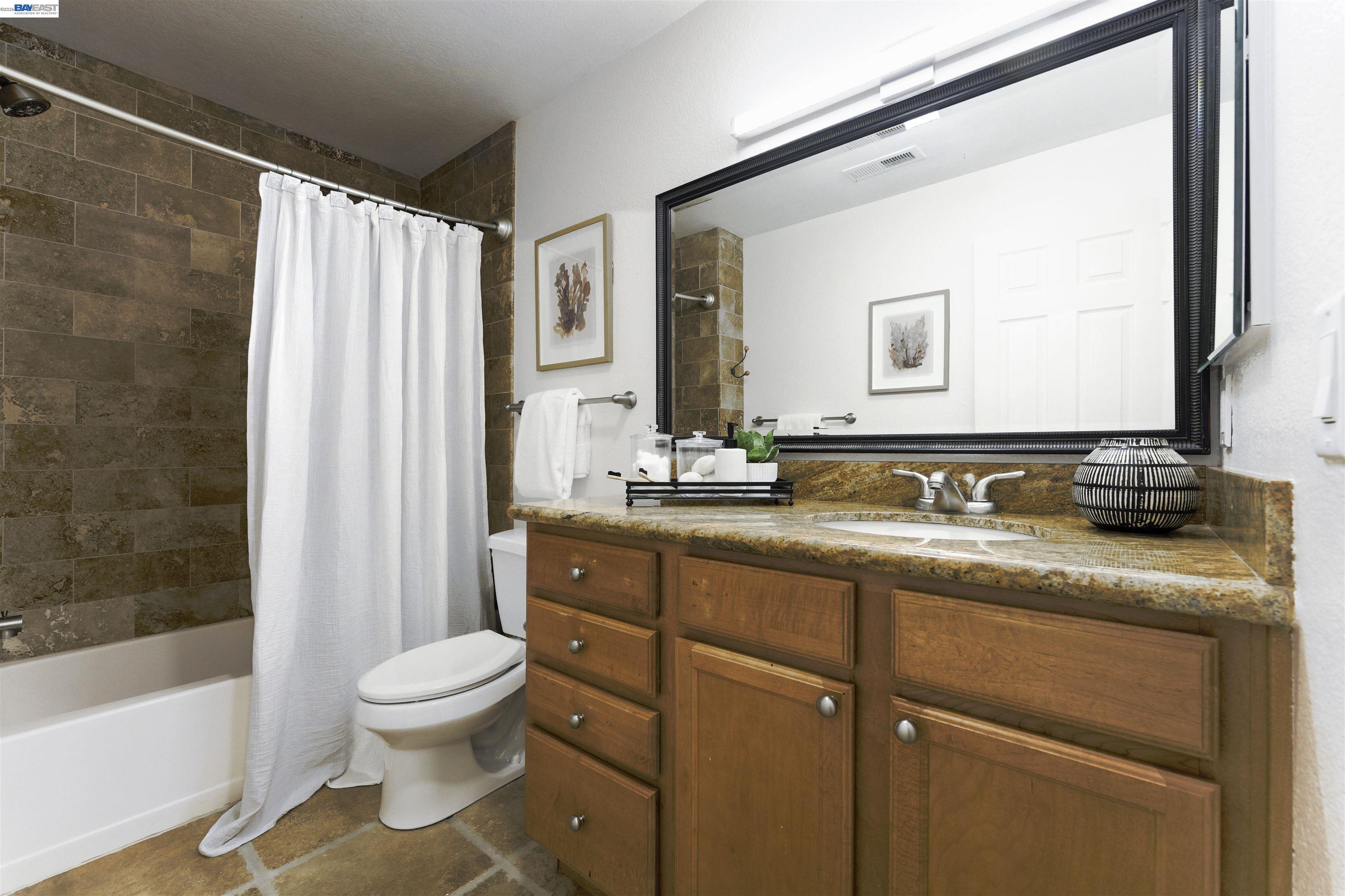 364 Eastridge Drive San Ramon, CA 94582 - Photo 17 of 23 a bathroom with a granite countertop sink toilet and shower