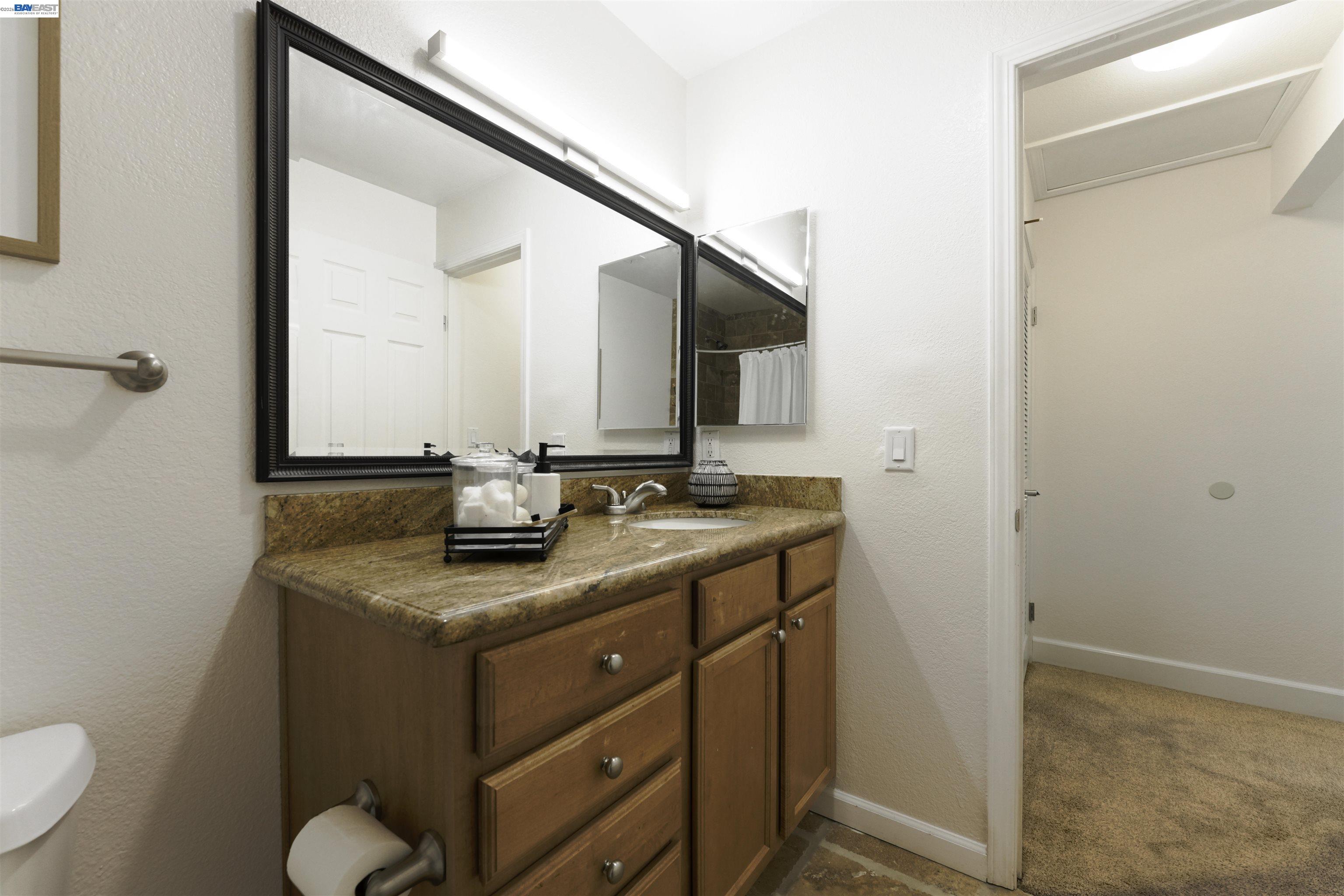 364 Eastridge Drive San Ramon, CA 94582 - Photo 18 of 23 a bathroom with a granite countertop sink and a mirror