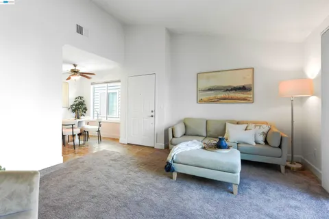 a living room with furniture and a dining room