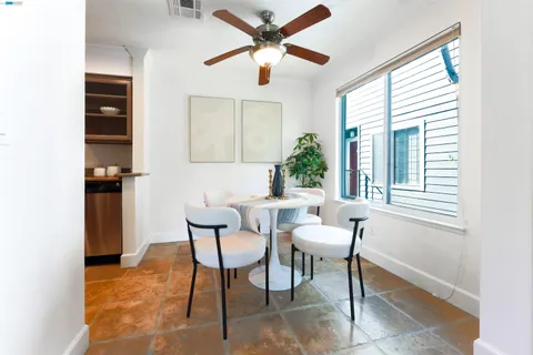 a dining room with furniture and window