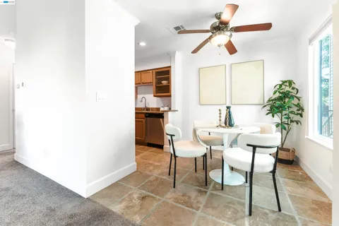a dining room with furniture and window
