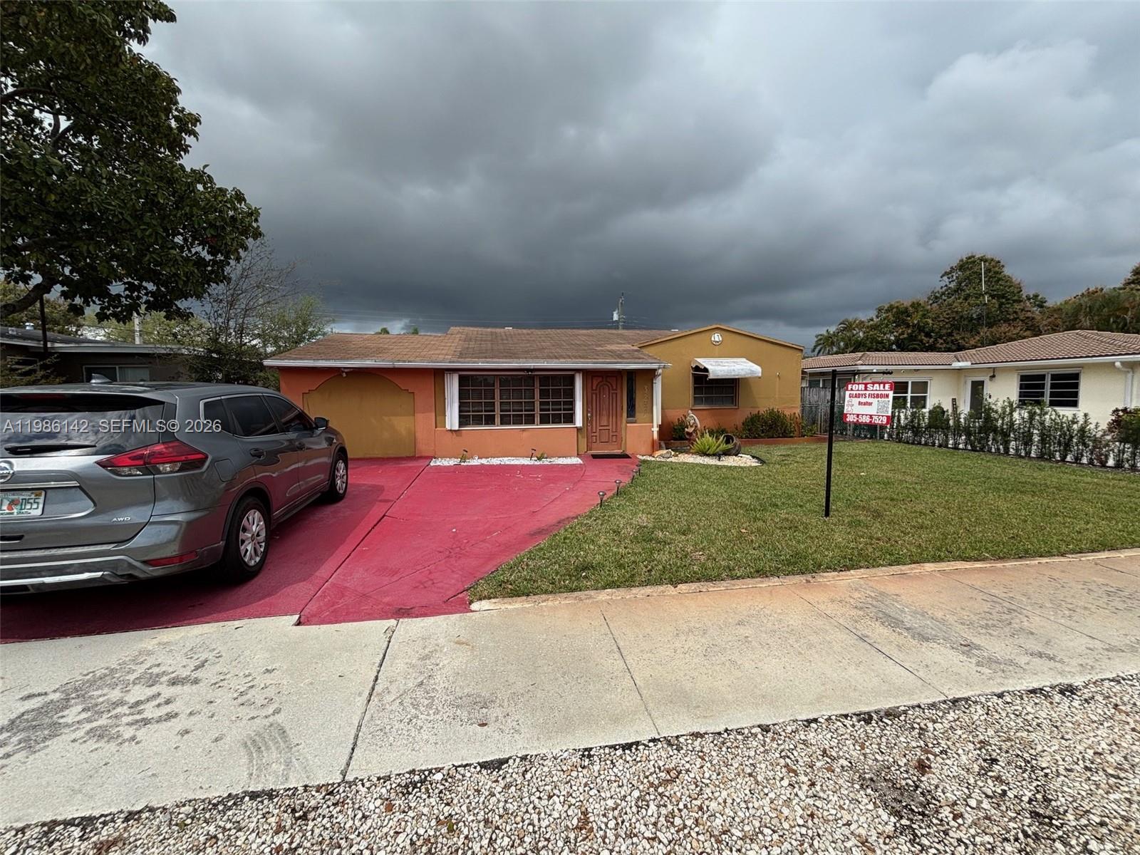 3241 Arthur Terrace Hollywood, FL 33021 - Photo 2 of 22 front view of a house with a yard