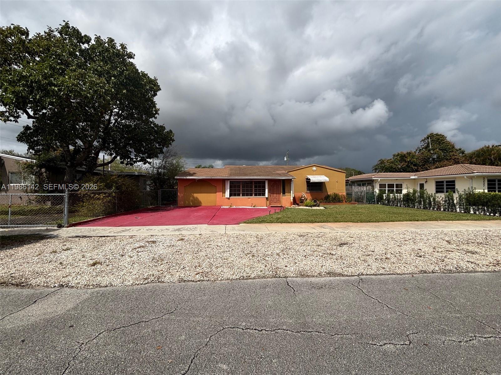 3241 Arthur Terrace Hollywood, FL 33021 - Photo 3 of 22 a front view of a house with a yard
