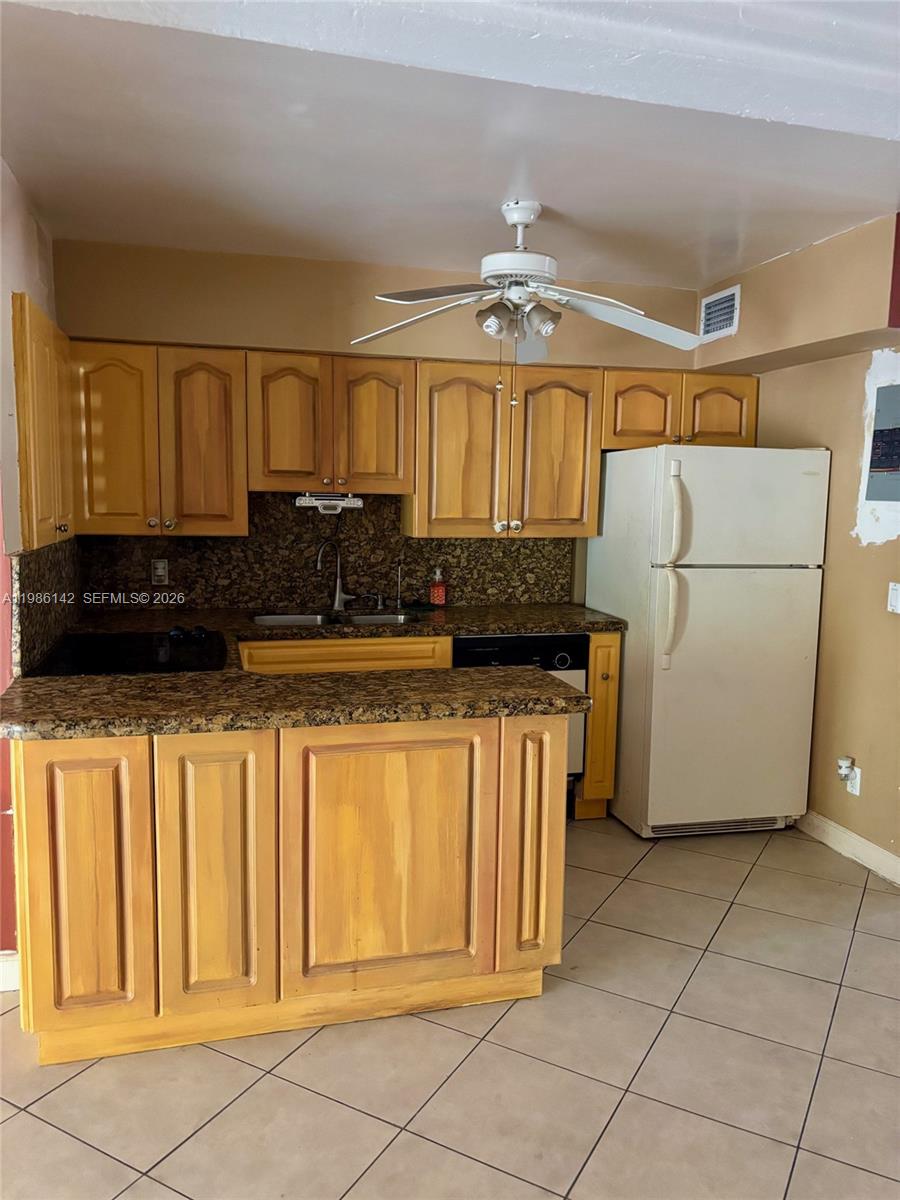 3241 Arthur Terrace Hollywood, FL 33021 - Photo 6 of 22 a kitchen with a refrigerator and cabinets