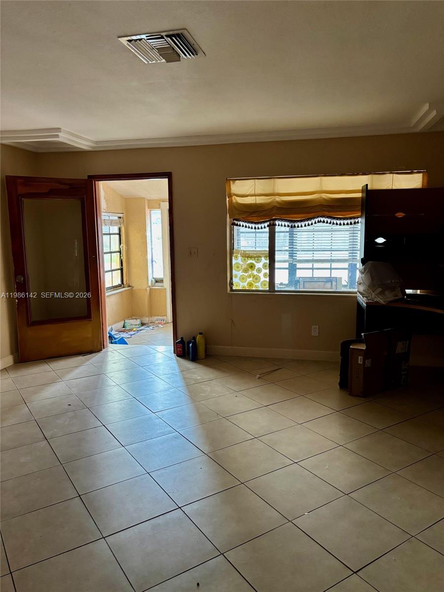 3241 Arthur Terrace Hollywood, FL 33021 - Photo 9 of 22 a view of an empty room with a fireplace and a window