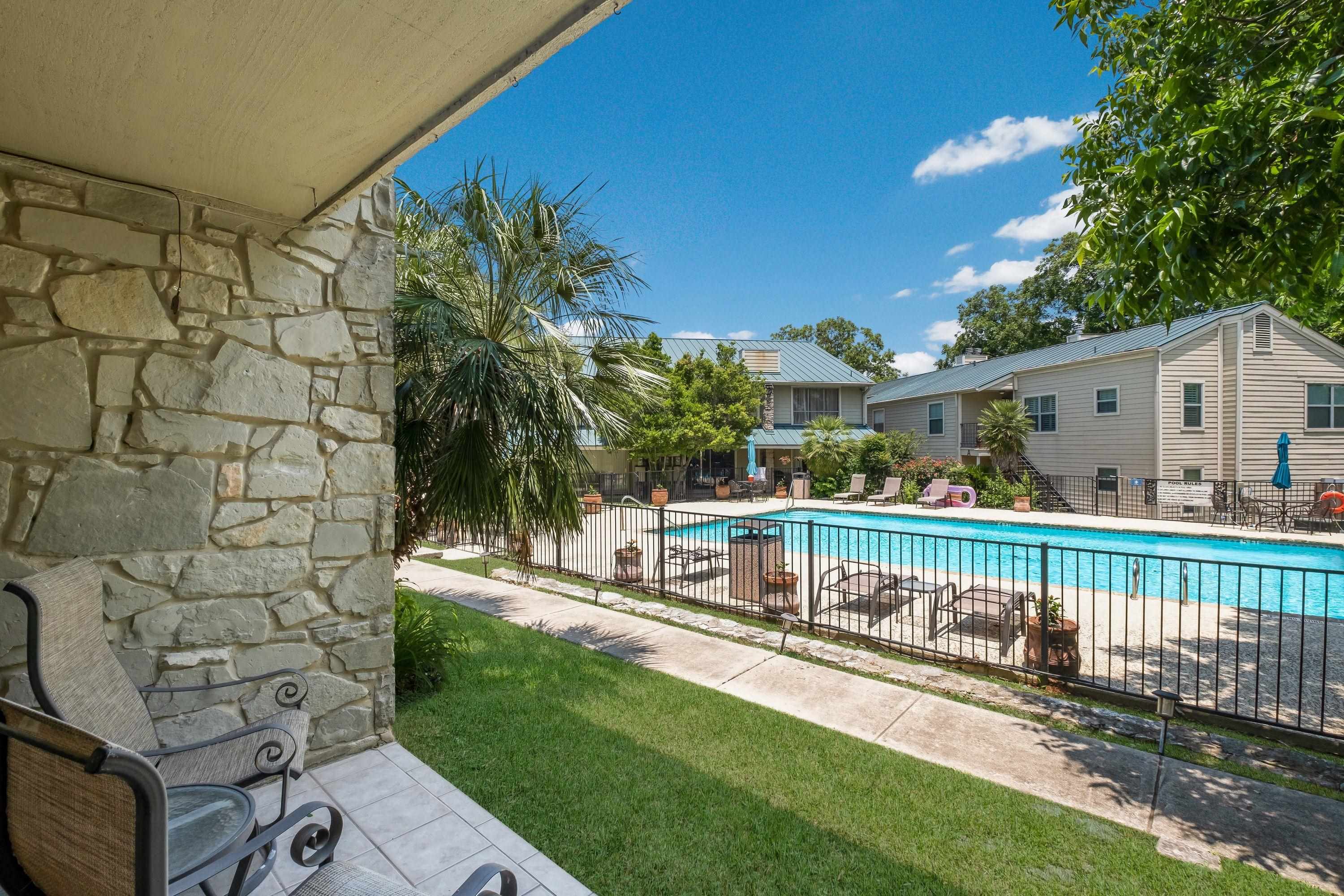 a view of a house with backyard and sitting area