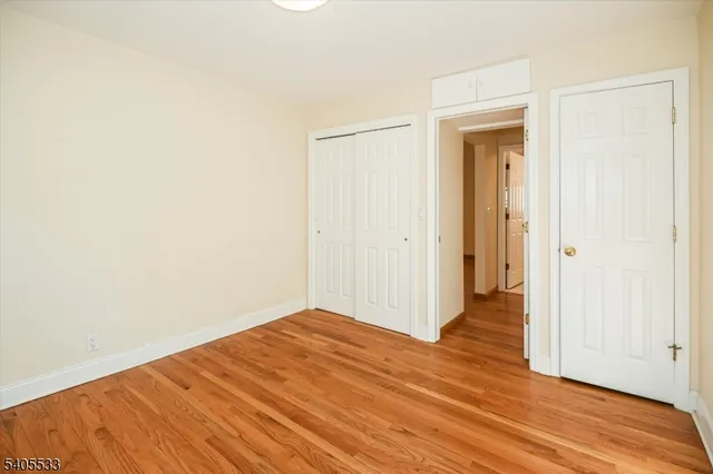 a view of a room with wooden floor and a bathroom
