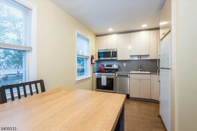 a kitchen with kitchen island a stove a sink and a microwave