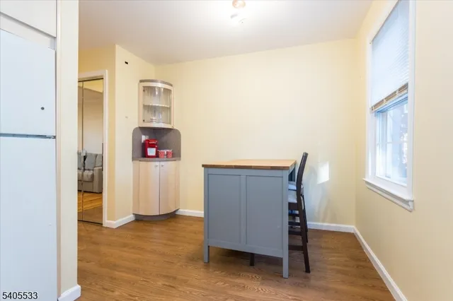 a view of a hallway with wooden floor and closet