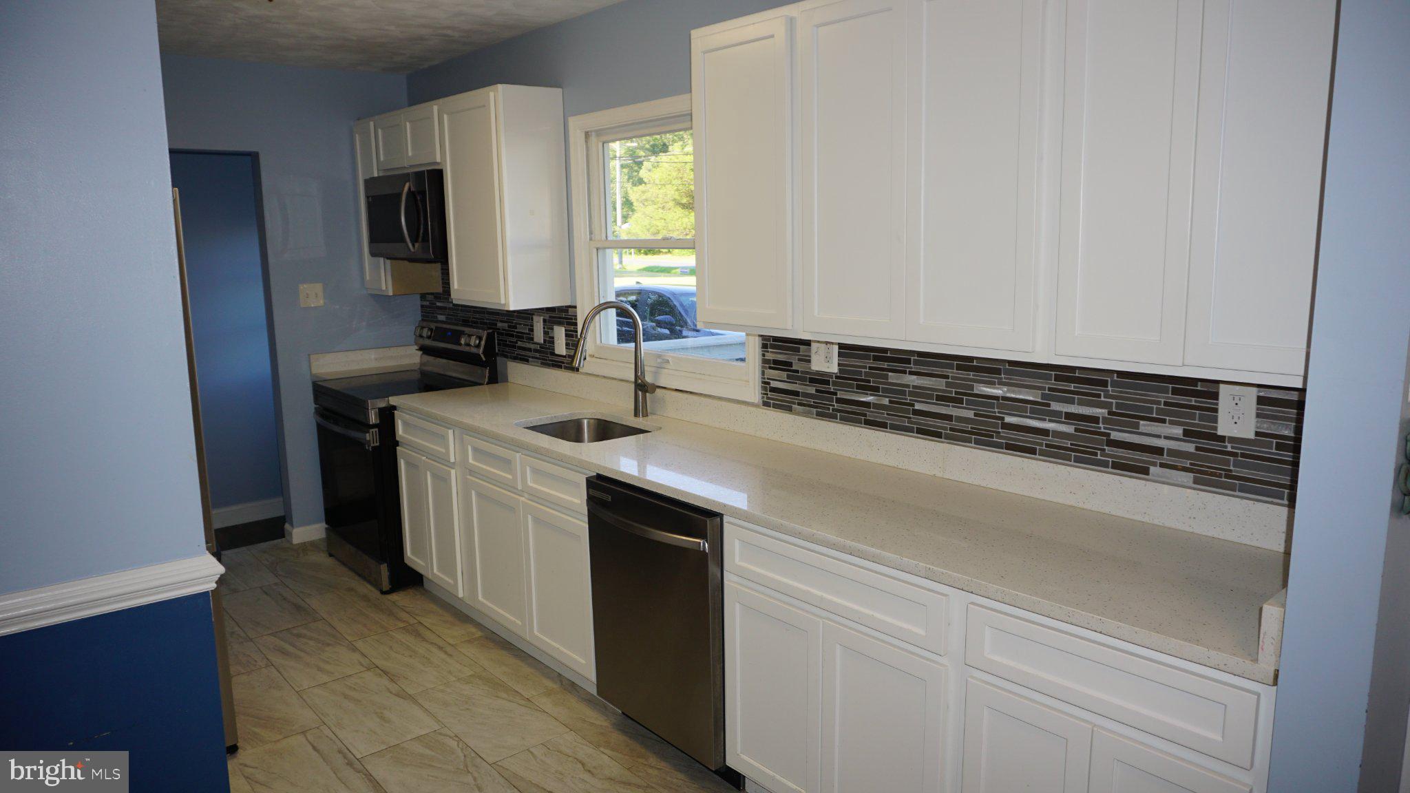 5854 Deale Churchton Road Deale, MD 20751 - Photo 15 of 57 Modern kitchen with sleek finishes.