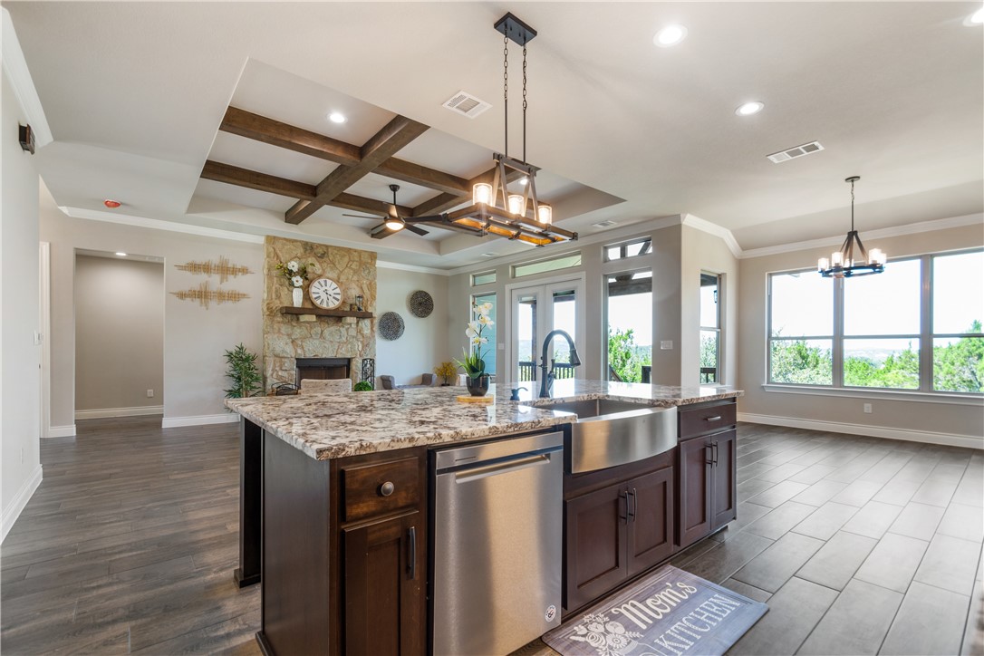 a kitchen with kitchen island granite countertop a sink appliances and a counter space