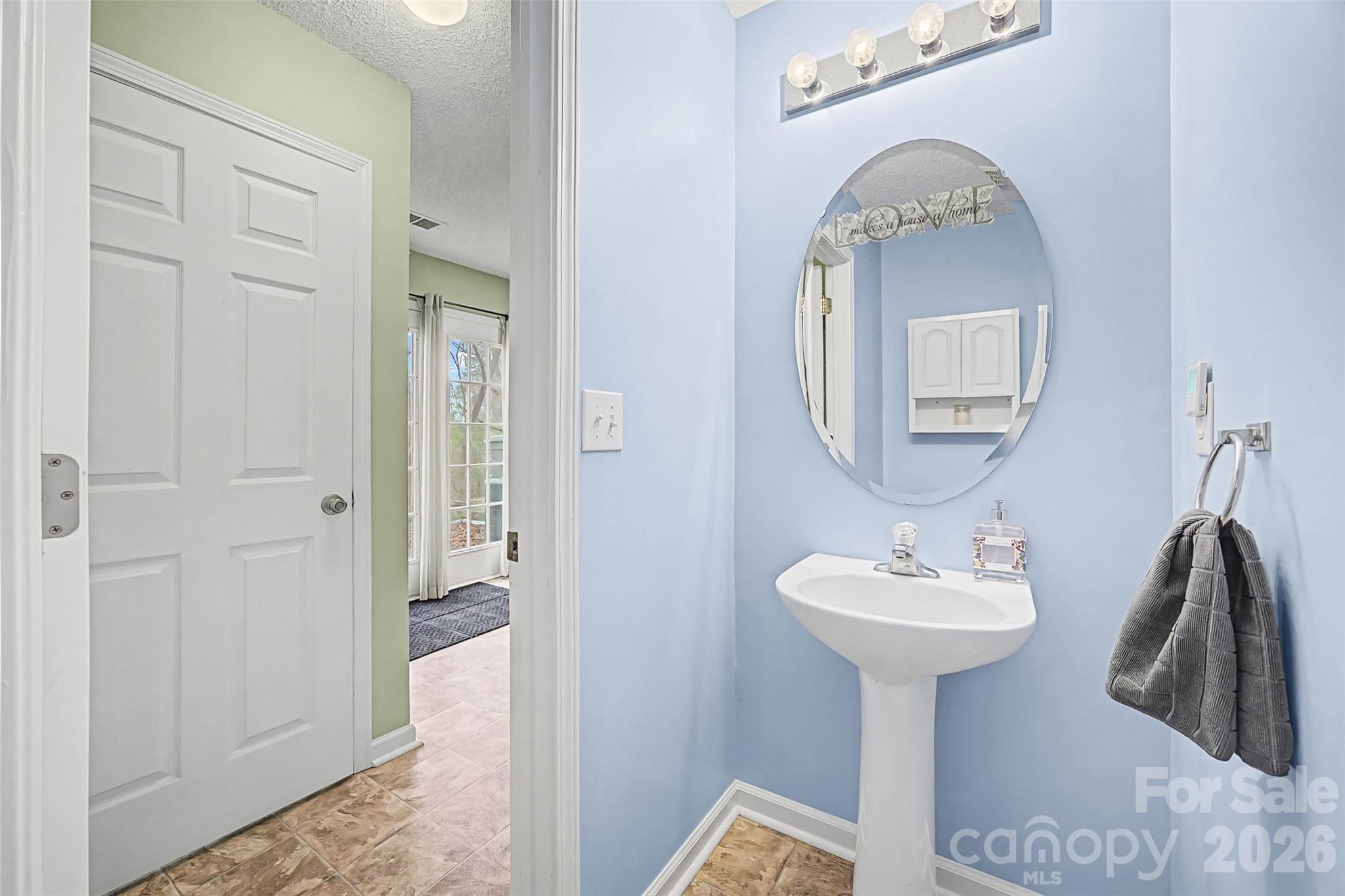232 Butler Place Fort Mill, SC 29715 - Photo 12 of 32 a bathroom with a sink and a mirror