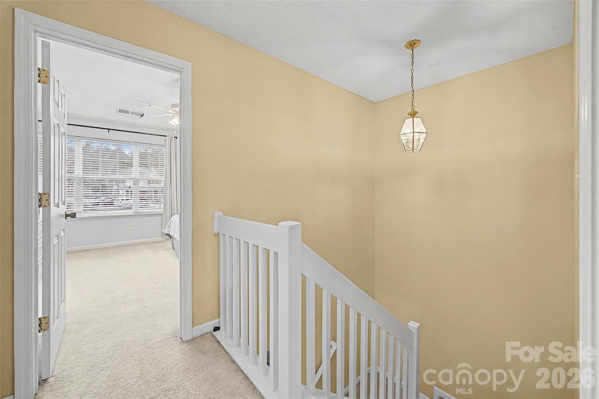 232 Butler Place Fort Mill, SC 29715 - Photo 14 of 32 a view of a hallway with a wooden floor
