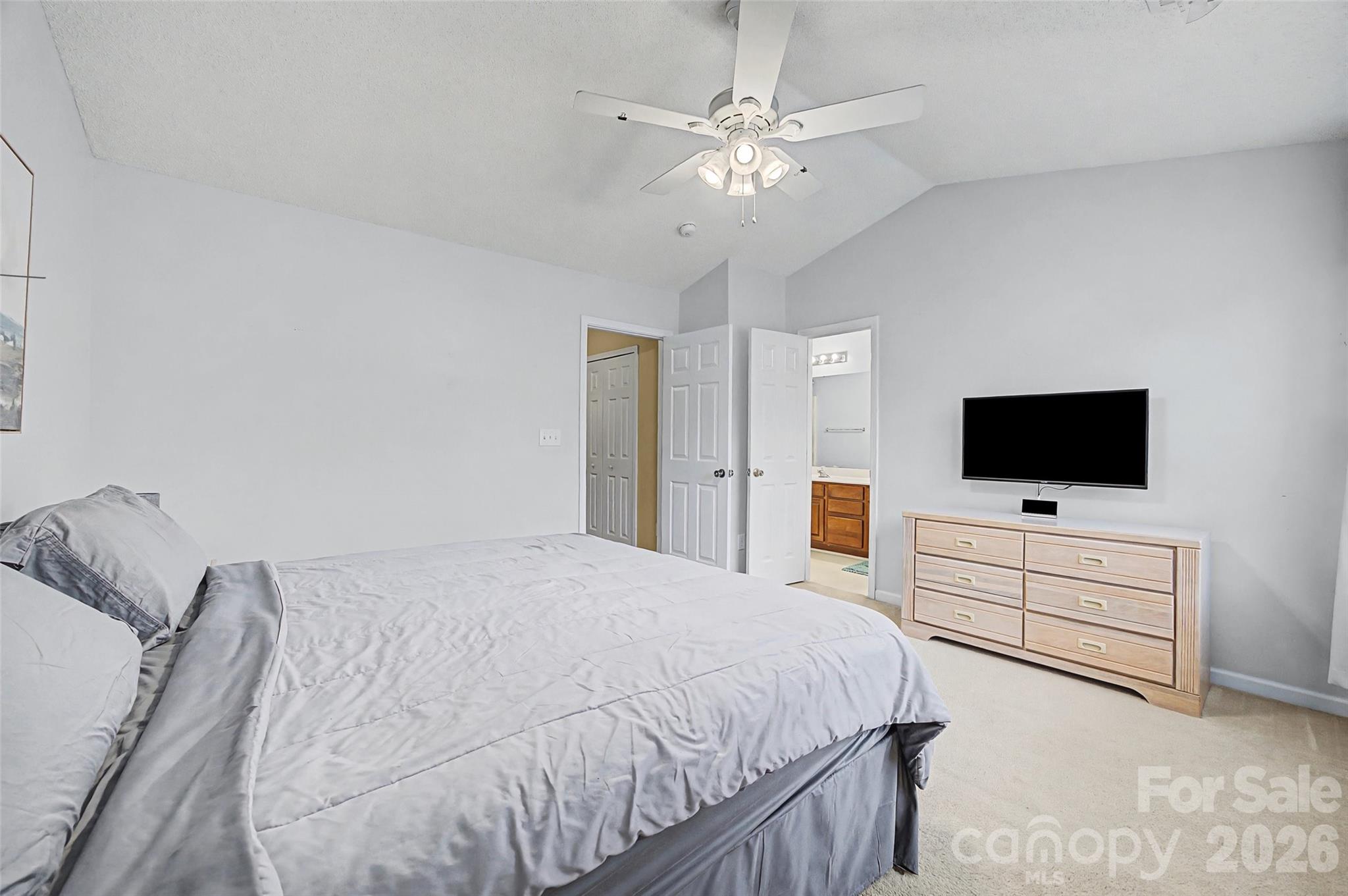 232 Butler Place Fort Mill, SC 29715 - Photo 16 of 32 a spacious bedroom with a bed and a flat screen tv