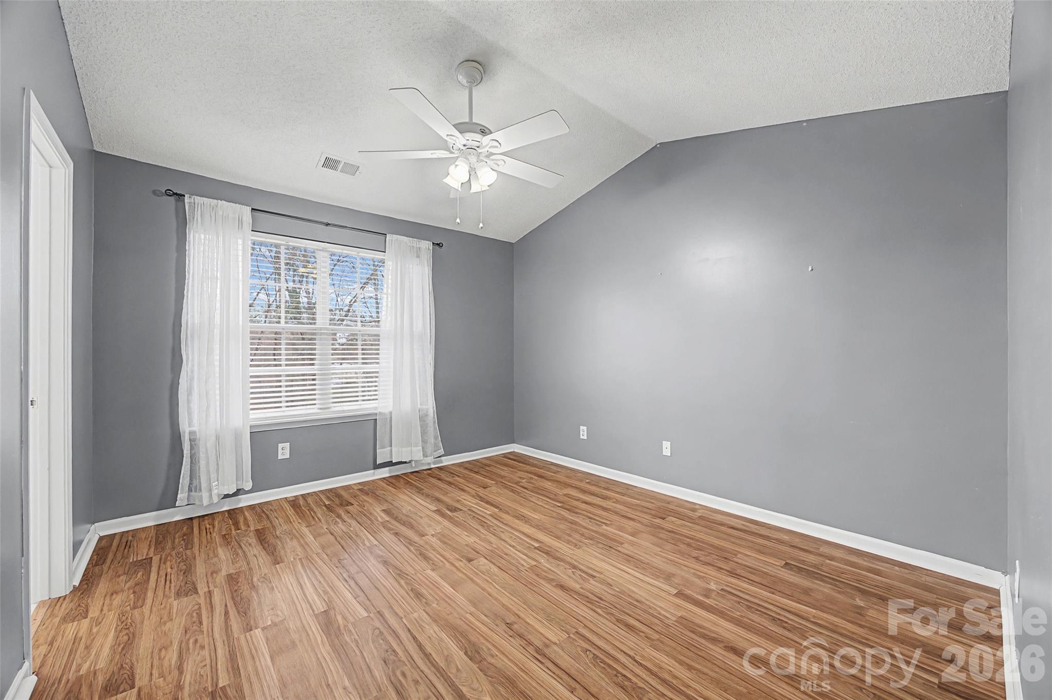 232 Butler Place Fort Mill, SC 29715 - Photo 19 of 32 a view of empty room with wooden floor and fan