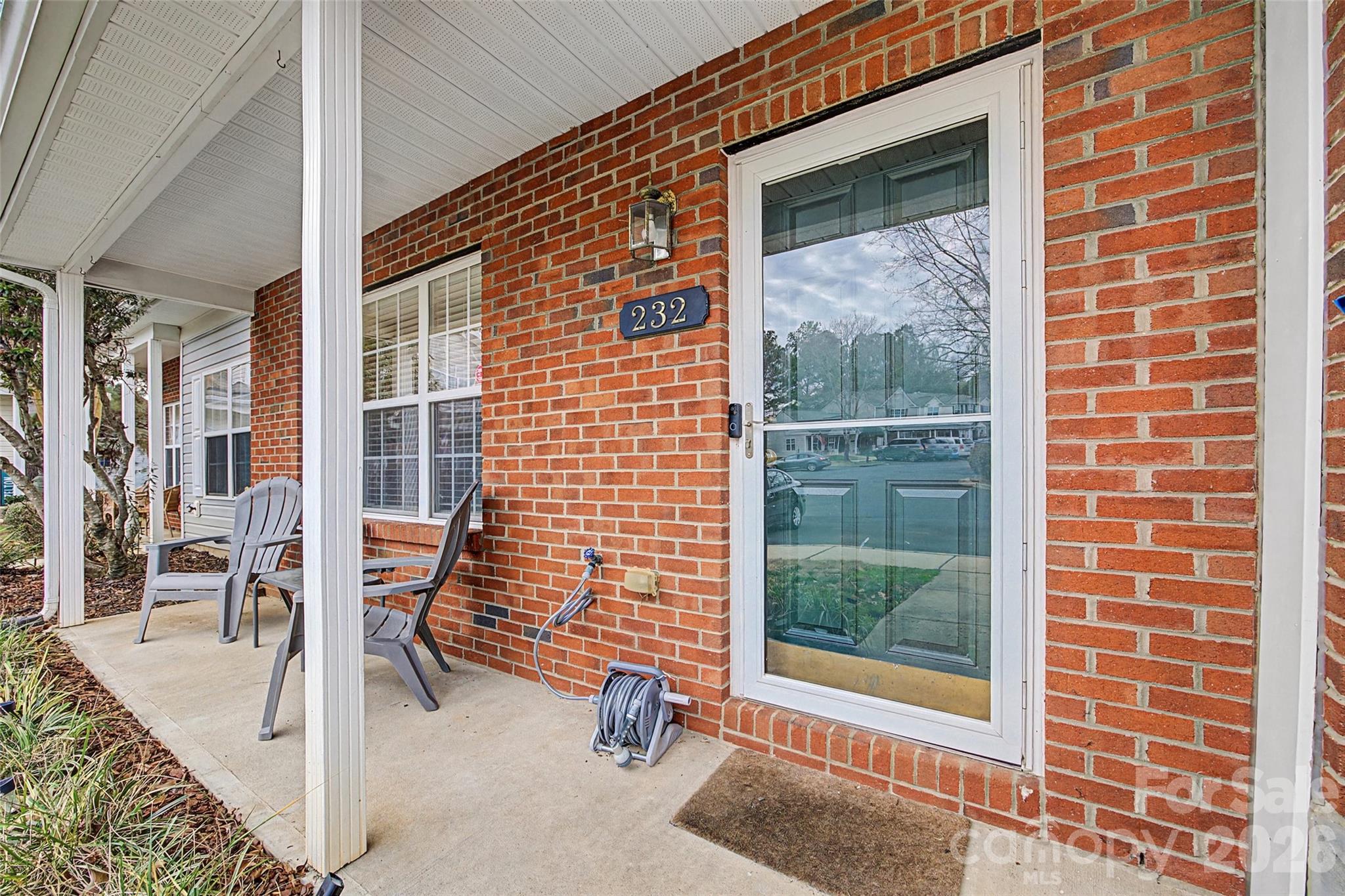 232 Butler Place Fort Mill, SC 29715 - Photo 2 of 32 a view of a patio with a table and chairs and floor to ceiling window