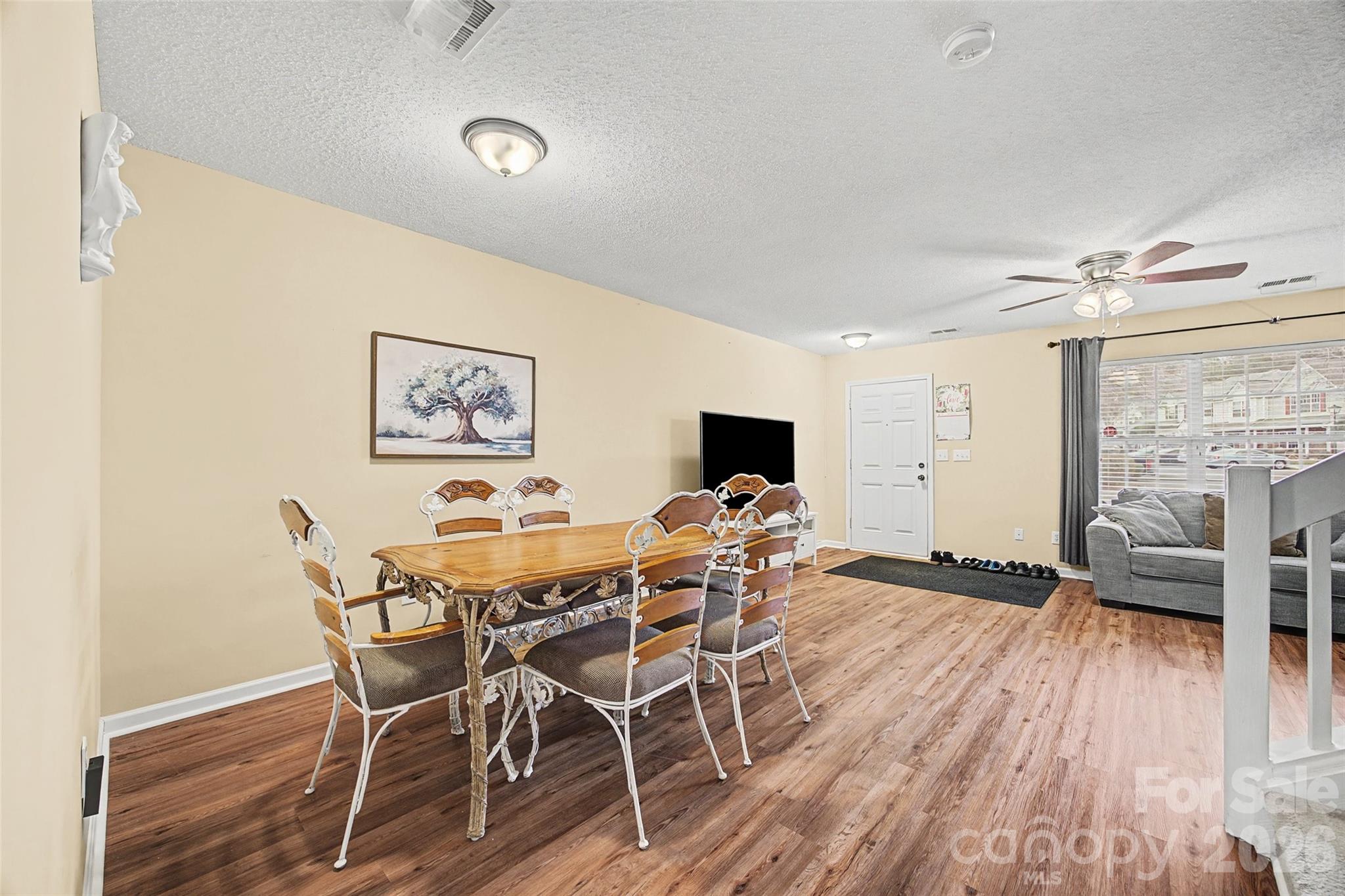 232 Butler Place Fort Mill, SC 29715 - Photo 7 of 32 a view of a dining room with furniture wooden floor and a rug