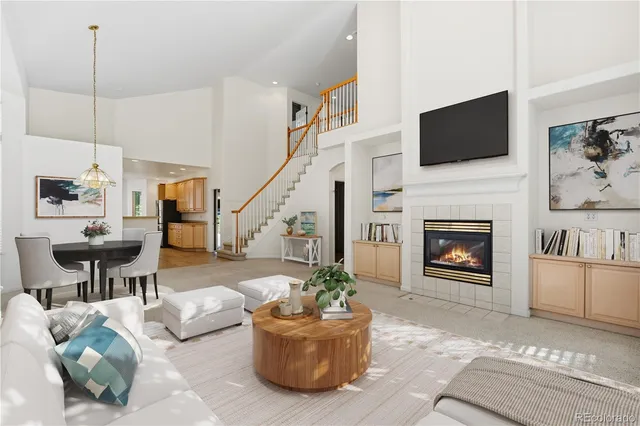an aerial view of a house with a yard and large tree