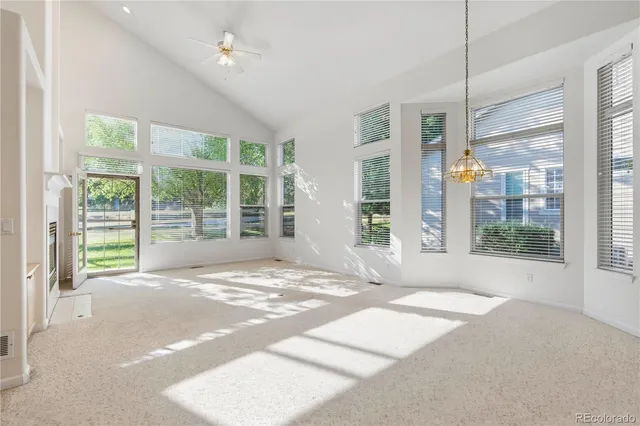 an aerial view of a house with a yard and plant in front of it