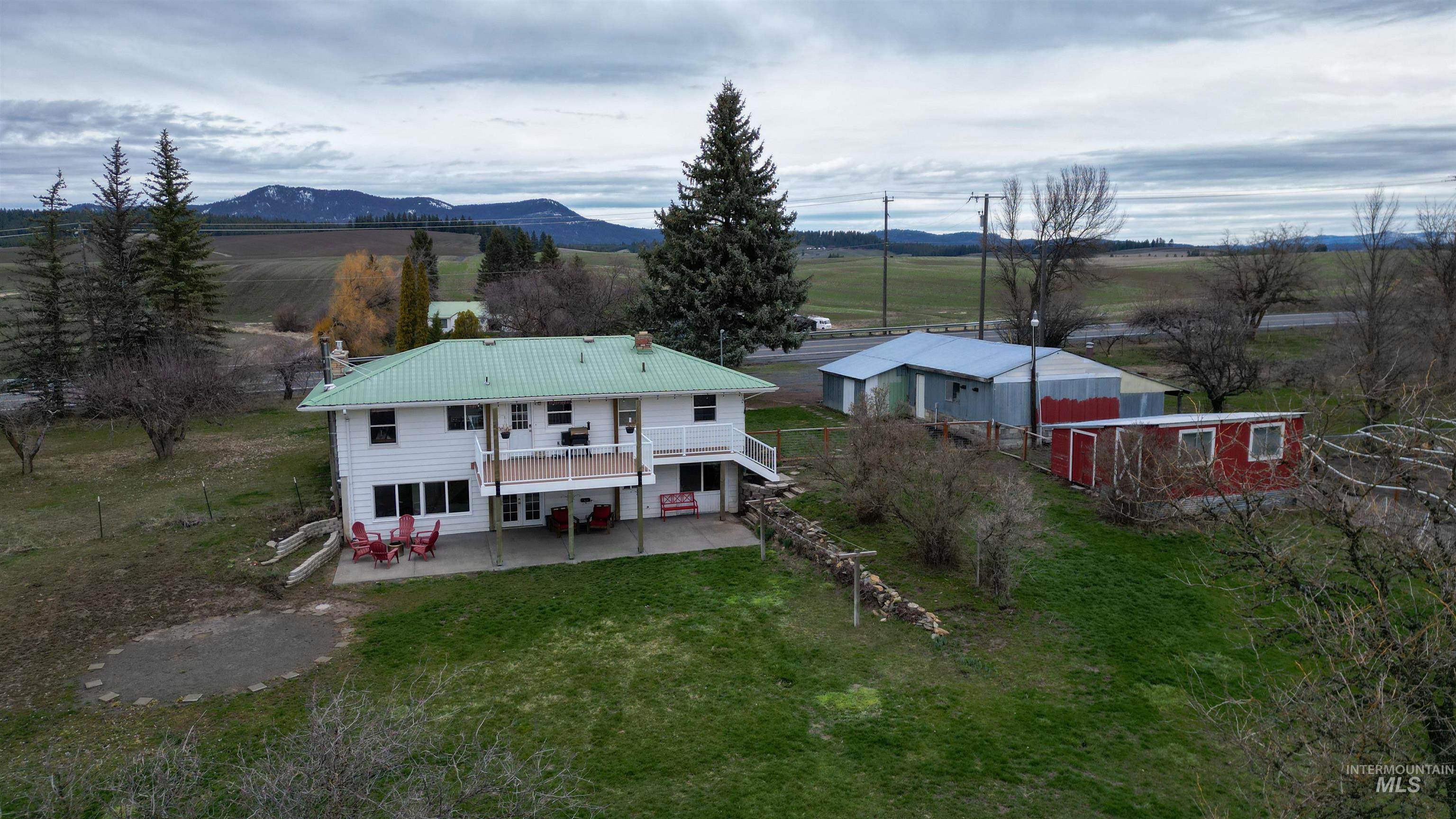 3611 Highway 8 Troy, ID 83871 - Photo 1 of 1 Rear view of house with a rural view, a patio, a deck with mountain view, and a yard